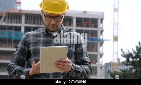 Architect On Building Site Using Digital Tablet. Stock Photo