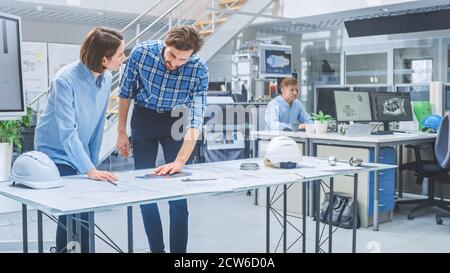 In the Busy Engineering Agency: Diverse Group of Engineers, Technicians, Specialists Working on Design for Industrial Engine Prototype. Professionals Stock Photo