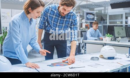 In the Busy Engineering Agency: Diverse Group of Engineers, Technicians, Specialists Working on Design for Industrial Engine Prototype. Professionals Stock Photo