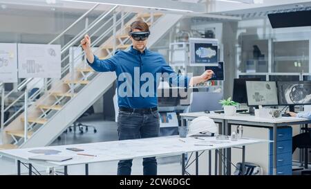 Engineering Software Developer Wearing Virtual Reality Headset Uses Gestures to Interact with Augmented Reality while Designing Industrial Engine Stock Photo