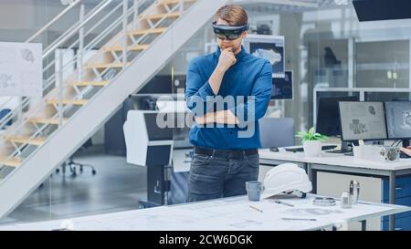 Engineering Software Developer Wearing Virtual Reality Headset Uses Gestures to Interact with Augmented Reality while Designing Industrial Engine Stock Photo