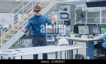 Engineering Software Developer Wearing Virtual Reality Headset Uses Gestures to Interact with Augmented Reality while Designing Industrial Engine Stock Photo