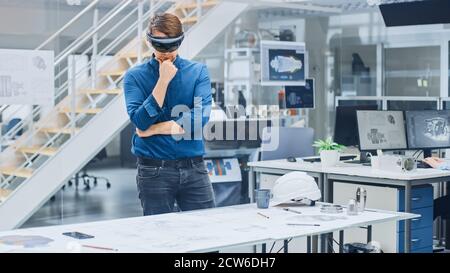 Engineering Software Developer Wearing Virtual Reality Headset Uses Gestures to Interact with Augmented Reality while Designing Industrial Engine Stock Photo