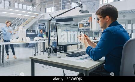 In Architectural Bureau: Team of Architects and Engineers Working on a Building Complex Prototype Project, Using City Model and Computers Running 3D Stock Photo