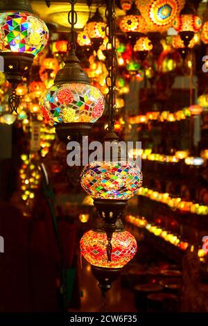 Vertical Image of Arabian Style Multi-color Mosaic Hanging Lamps in a Dark Room Stock Photo