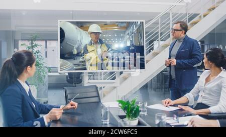 In the Conference Room Group of Directors, Investors and Businessmen Making Video Conference Call To Talk with Professional Female Engineer with Stock Photo