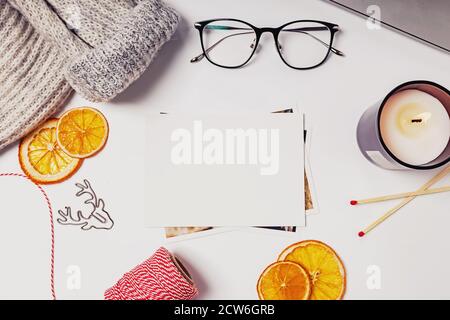 Greeting card mock-up. Christmas flat lay composition with candle, dry oranges and other items Stock Photo