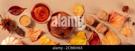 Autumn panorama. A banner with autum leaves, sweet wine, and cookies, a flat lay, fall atmosphere Stock Photo