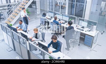 Diverse Multinational Team of Business Managers and Specialists Work on Desktop Computers, Have Discussion with Colleagues. Young and Motivated Stock Photo