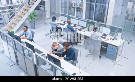 Diverse Multinational Team of Business Managers and Specialists Work on Desktop Computers, Have Discussion with Colleagues. Young and Motivated Stock Photo