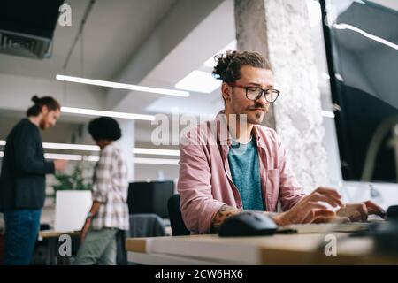 Programmer working and developing software in office Stock Photo