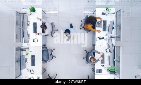 Top Down Shot of Big Busy Corporate Office with Two Rows off Businessmen and Businesswomen Working on Desktop Computers. Director is Walking Between Stock Photo