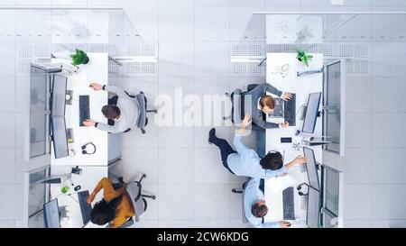 Top Down Shot of Big Busy Corporate Office with Tow Rows off Businessmen and Businesswomen Working on Desktop Computers. Bright Open Space Office with Stock Photo