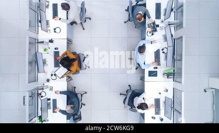 Top Down Shot of Big Busy Corporate Office with Tow Rows off Businessmen and Businesswomen Working on Desktop Computers. Bright Open Space Office with Stock Photo