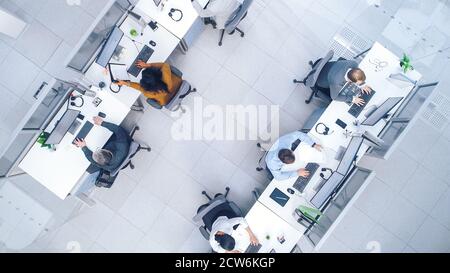 Top Down Shot of Big Busy Corporate Office with Tow Rows off Businessmen and Businesswomen Working on Desktop Computers. Bright Open Space Office with Stock Photo