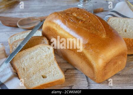 loaf of white bread on wooden table Stock Photo