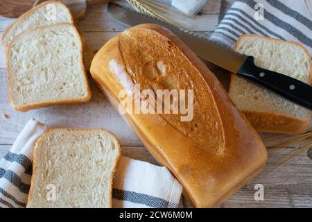 loaf of white bread on wooden table Stock Photo