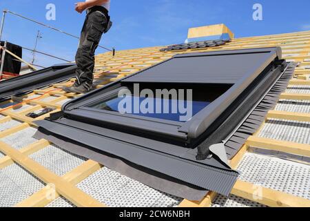Installation and assembly of new roof windows as part of a roof covering Stock Photo