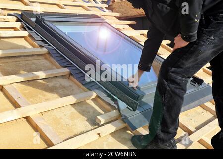 Installation and assembly of new roof windows as part of a roof covering Stock Photo