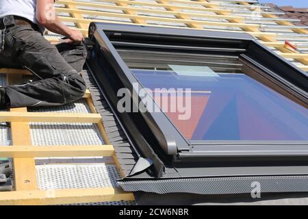 Installation and assembly of new roof windows as part of a roof covering Stock Photo