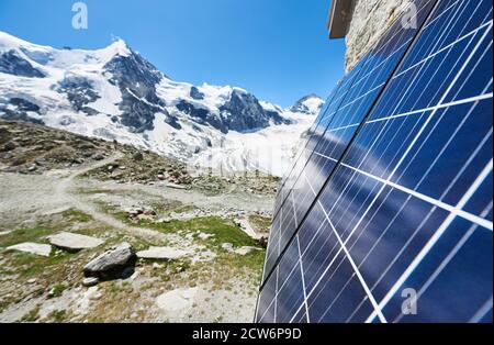 Close-up perspective snapshot of solar panels installed on the walls of alpine hut in Swiss Alps as alternative source of energy, concept of green ecology Stock Photo