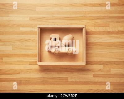 Wooden mixer truck toy inside a wooden box with a wooden texture background too Stock Photo