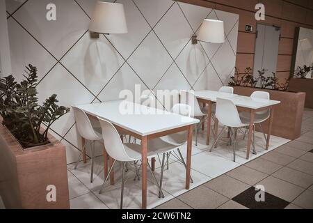 White stools and white tables at cafe Stock Photo