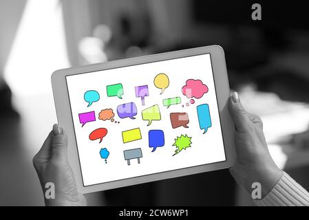 Communication concept shown on a tablet held by a woman Stock Photo