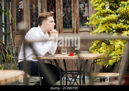 Waiting for girlfriend in outdoor cafe Stock Photo