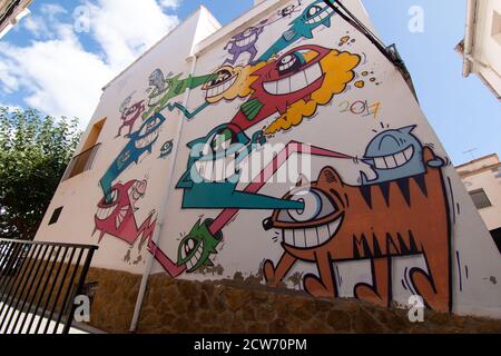 Fanzara (Castellón), Spain - September 20, 2020: Graffiti on a facade of a small town in Castellón (Spain) made by the artist Pez as part of MIAU (Unf Stock Photo