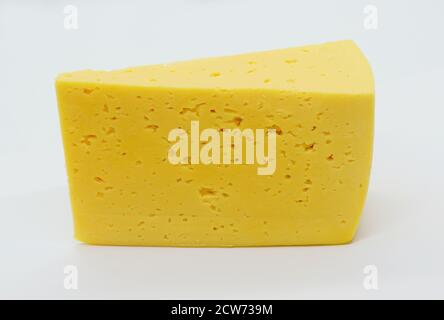 Cow's milk semi-hard cheese piece, slice of russian, sour creamy, gouda cheese isolated on white background. Stock Photo