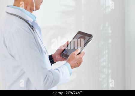 Physician video calling colleague Stock Photo