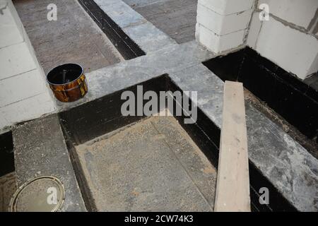 A close-up on waterproofing, damp proofing flooring with bitumen paint spray,  liquid rubber foundation and basement sealant indoors Stock Photo - Alamy