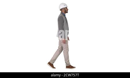 Architect in white helmet walking on white background. Stock Photo