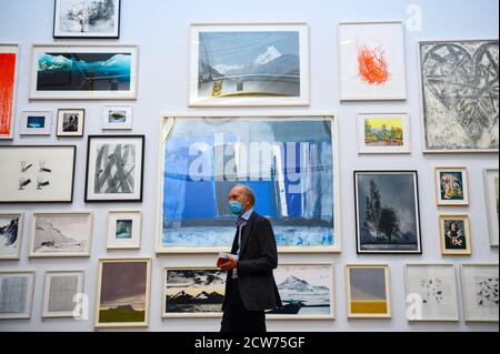 NOTE TO EDITORS. FOR USE IN RELATION TO THE EXHIBITION ONLY. A member of the public looks at various artworks at a preview for the 'summer' exhibition at the Royal Academy of Arts in London. The 252nd Summer Exhibition was postponed because of the coronavirus pandemic and will take place in the autumn for the first time. Stock Photo