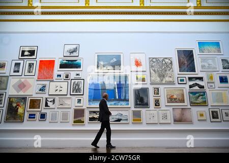 NOTE TO EDITORS. FOR USE IN RELATION TO THE EXHIBITION ONLY. A member of the public looks at various artworks at a preview for the 'summer' exhibition at the Royal Academy of Arts in London. The 252nd Summer Exhibition was postponed because of the coronavirus pandemic and will take place in the autumn for the first time. Stock Photo