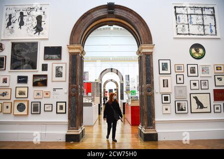 NOTE TO EDITORS. FOR USE IN RELATION TO THE EXHIBITION ONLY. A member of the public looks at various artworks at a preview for the 'summer' exhibition at the Royal Academy of Arts in London. The 252nd Summer Exhibition was postponed because of the coronavirus pandemic and will take place in the autumn for the first time. Stock Photo