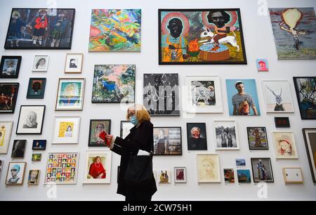 NOTE TO EDITORS. FOR USE IN RELATION TO THE EXHIBITION ONLY. A member of the public looks at various artworks at a preview for the 'summer' exhibition at the Royal Academy of Arts in London. The 252nd Summer Exhibition was postponed because of the coronavirus pandemic and will take place in the autumn for the first time. Stock Photo