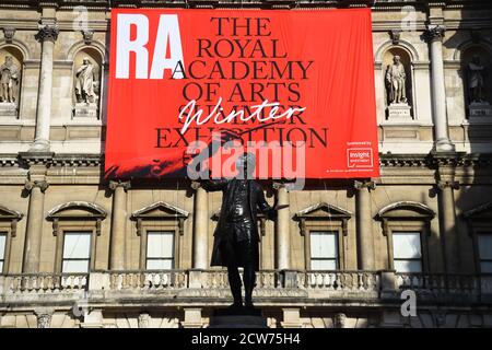 NOTE TO EDITORS. FOR USE IN RELATION TO THE EXHIBITION ONLY. The statue of Sir Joshua Reynolds wearing a mask outside the Royal Academy of Arts in London. The 252nd Summer Exhibition was postponed because of the coronavirus pandemic and will take place in the autumn for the first time. Stock Photo