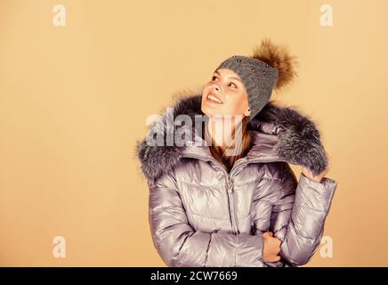 Fashion coat and hat. Fashion trend. Faux fur. Warming up. Casual winter jacket slightly more stylish and have more comfort features such as larger hood fur trim on hood. Fashion girl winter clothes. Stock Photo