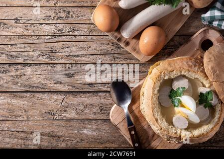 Zurek. Traditional Polish soup on wooden table Stock Photo