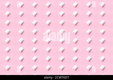 White-pink marshmallows placing on pink flatlay. Marshmallow pattern on pink background Stock Photo