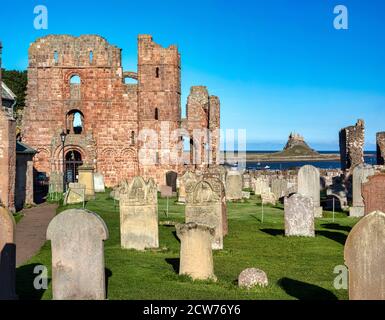 Lindisfarne Priory and Lindisfarne Castle in summer on Lindisfarne near Berwick upon Tweed, Northumberland, England, United Kingdom Stock Photo