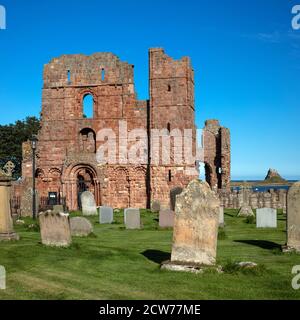 Lindisfarne Priory and Lindisfarne Castle in summer on Lindisfarne near Berwick upon Tweed, Northumberland, England, United Kingdom Stock Photo