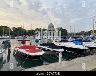Boats docked in Wilmette Harbor on Lake Michigan with the Baha'i House of Worship in the background