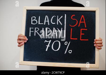 Sale 70% written on blackboard. Black friday concept. Boy hold board. Stock Photo