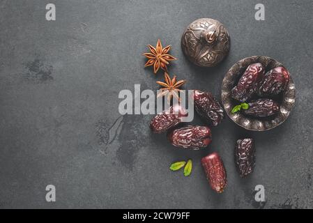 Dried dates, dried fruit on black background. Top view copy space. Arabic Islamic food Stock Photo