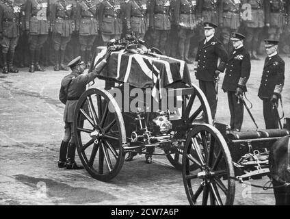 LONDON - NOVEMBER 11: King George V places a wreath on the coffin of the Unknown Warrior in Whitehall, London, prior to his internment in Westminster Abbey, on November 11, 1920. Stock Photo