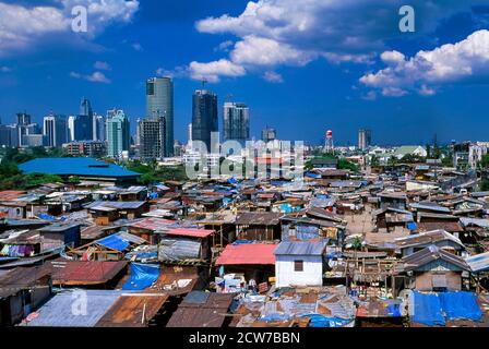 Contrast between Makati skyscrapers and Guadalupe shanty town, Metro Manila, Philippines