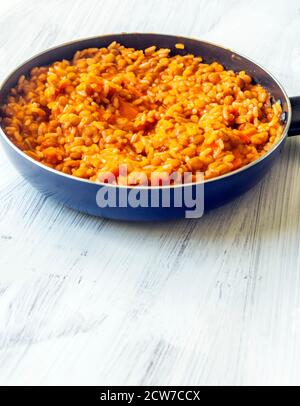 Lentils and rice in a pan surrounded by white background Stock Photo